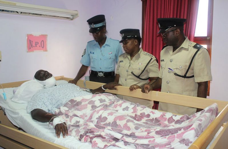 Members of the Guyana Police Force (GPF) visit Constable Michael Grimmond at the St. Joseph Mercy Hospital