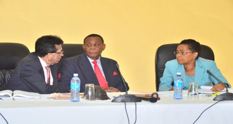 From left Commissioners Seenauth Jairam, Chairman Sir Richard Cheltenham, and Jacqueline Samuels- Brown debate a point before making a ruling (Photos by Adrian Narine)