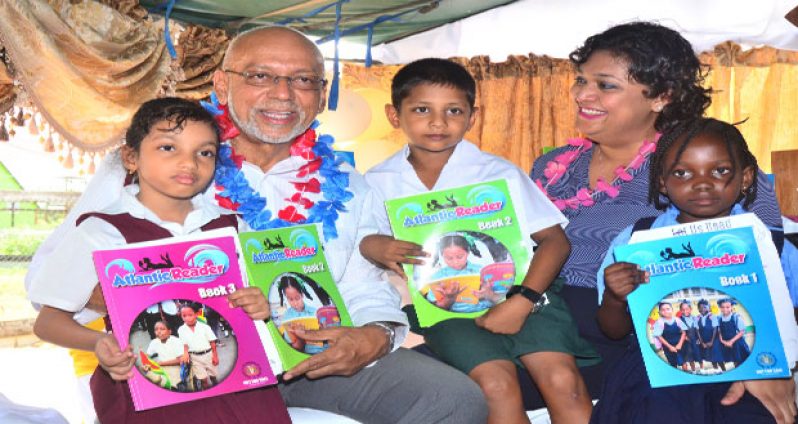 President Donald Ramotar and Education Minister Priya Manickchand with primary school students at yesterday’s launch of the locally produced Atlantic Readers books (Adrian Narine photo)