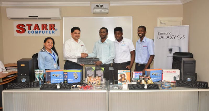 Starr Computer General Manager, Rehman Majeed hands over IT equipment to GTI’s Revon Thorman (Photo by Samuel Maughn)