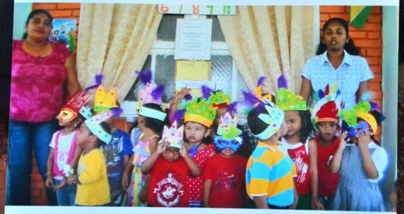 Principal Surasattie Walker (left) and children of Precious Gems Playschool during a school party.  At right is Teacher Sharda