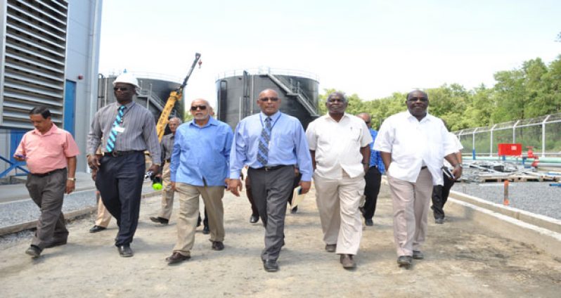 President Donald Ramotar, with Guyana Power and Light Company Chief Executive Officer Bharat Dindyal and Transport Minister Robeson Benn , third and second right, and others during a tour of the newly commissioned Vreed-en-Hoop Power Station