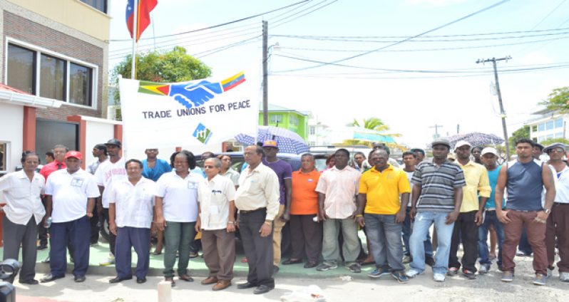 Trade unionists and workers outside the Embassy of the Bolivarian Republic of Venezuela in Georgetown yesterday before presenting the Ambassador with a signed Peace Declaration
