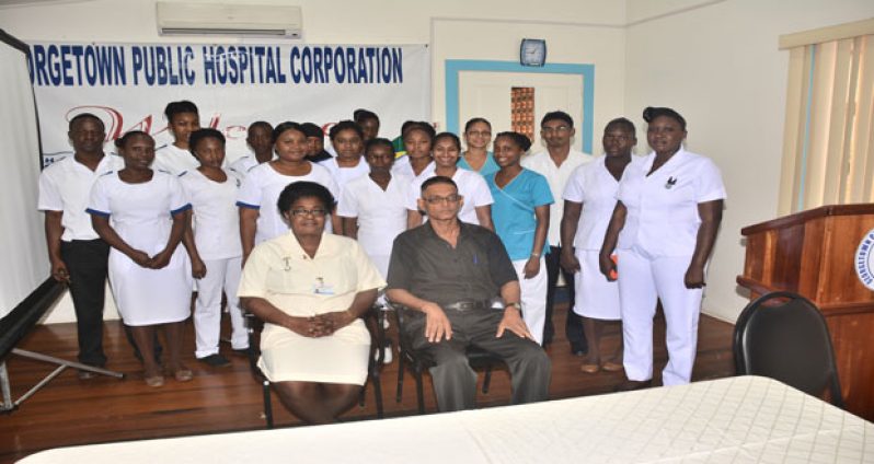 Manager of Training and Development of GPHC, Mr. Soogrim Singh, and Clinical Supervisor, Ms. Gail Gill are flocked by trainees of the Operating Room Technician programme