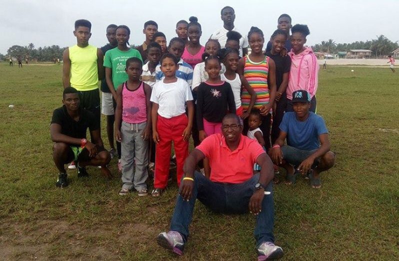 Coach Moses Pantlitz (seated in foreground) with some CWSS Track Club members at the Bayroc Ground
