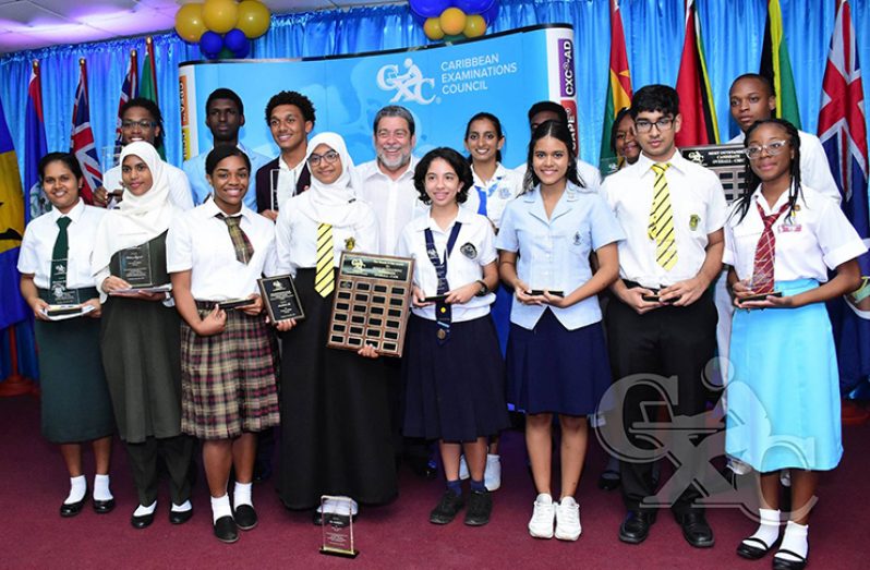 All of the regional awardees, including the Guyanese top performers, pose with their awards