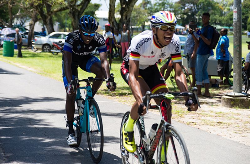 Christopher ‘Chicken Legs’ Griffith (front) reacts on winning the 14th edition of the Laparkan Holdings’ 11-Race cycling meet, ahead of last year’s winner Andrew Hicks. (Delano Williams photo)