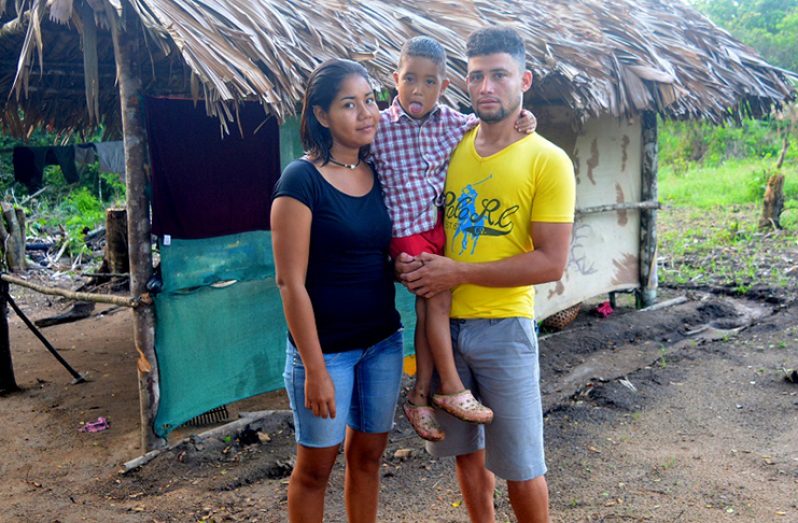 Venezuelan migrants Rosalinda and Victor Mercano outside the thatch-roof shelter they built recently at White Water, close to the Venezuelan border