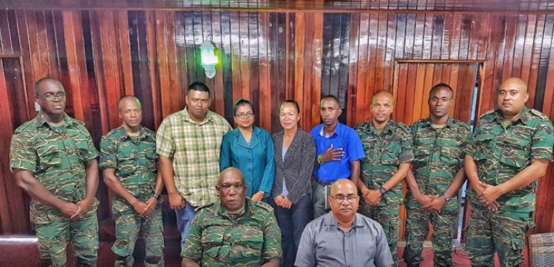 Officers from the Guyana People’s Militia posing with Regional Executive Officer, Denis Jaikarran and other regional officials in the boardroom of the Regional Democratic Council