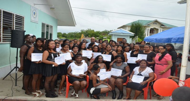 Minister Juan Edghill, Rima Rohee and the graduands of the single parents training programme under the Ministry of Labour’s Board of Industrial Training (BIT) programme at Soesdyke