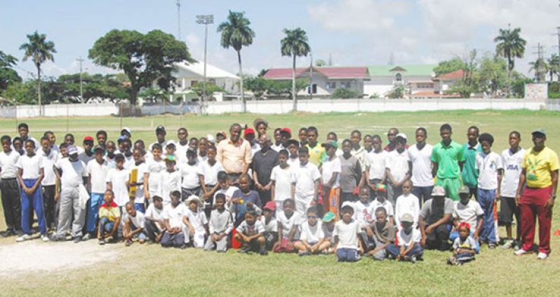 Flashback! 2015 annual summer camp – Centre Alfred Mentore, Minister Keith Scott and further right is Coach Garvin Nedd, with a portion of the participants at Demerara Cricket Club (DCC), in Queenstown