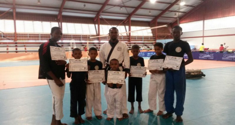 Sensei Roland Eudoxie stands with his graduates.