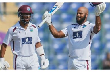 John Campbell (right) celebrates after scoring his maiden Test century, while Shai Hope looks on