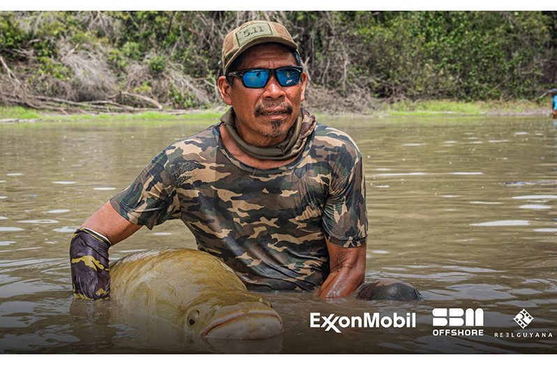 James Campbell during a rescue operation of trapped arapaimas. He took the time out to pose with one of the 60 arapaimas that were relocated to the river