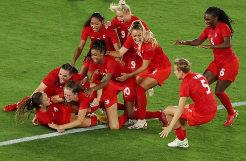 Canadian women footballers celebrate their gold medal triumph,