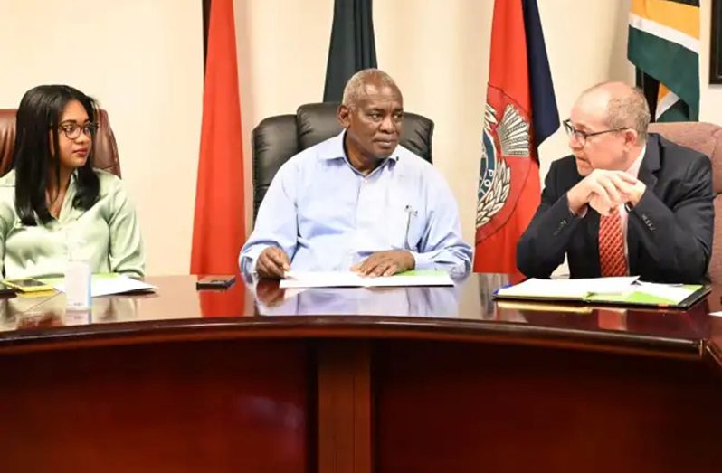 Minister of Home Affairs Robeson Benn (centre) flanked by Permanent Secretary Mae Toussaint Jr. Thomas and Canadian High Commissioner to Guyana Mark Berman during the handing over of the equipment