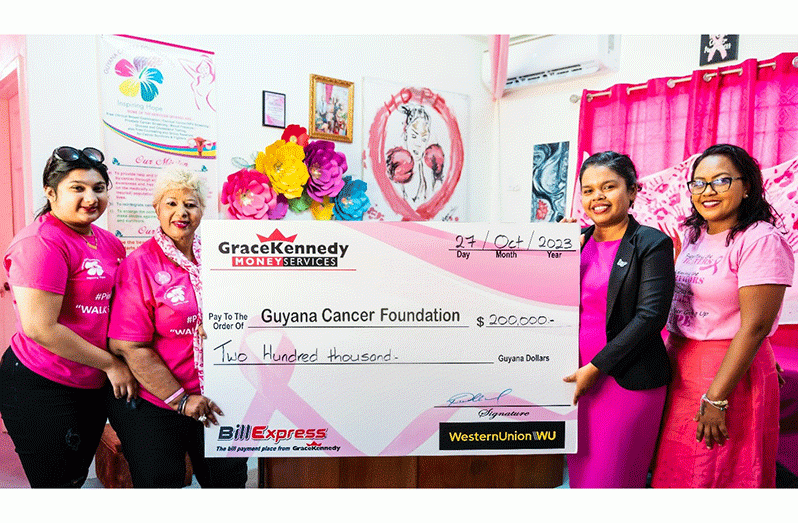 Tina Seabra-Gibson and Margo Boodoo, Marketing Officer and Customer Service Representative of GKMS hand over the cheque to Founder and President of the Guyana Cancer Foundation, Bibi Hassan, holding the cheque