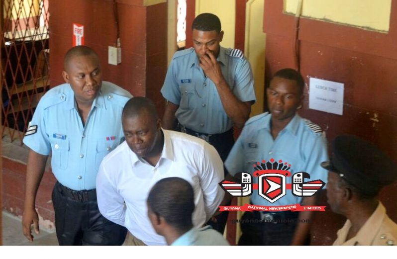 GDF Captain Orwain Sandy (in white shirt) at the Georgetown Magistrate's Court on Friday.