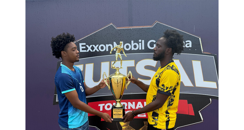 The captains of YMCA Keyshawn Dey (right) and Silver Bullets Rodensio Tudor face-off with the coveted championship trophy ahead of tonight’s final