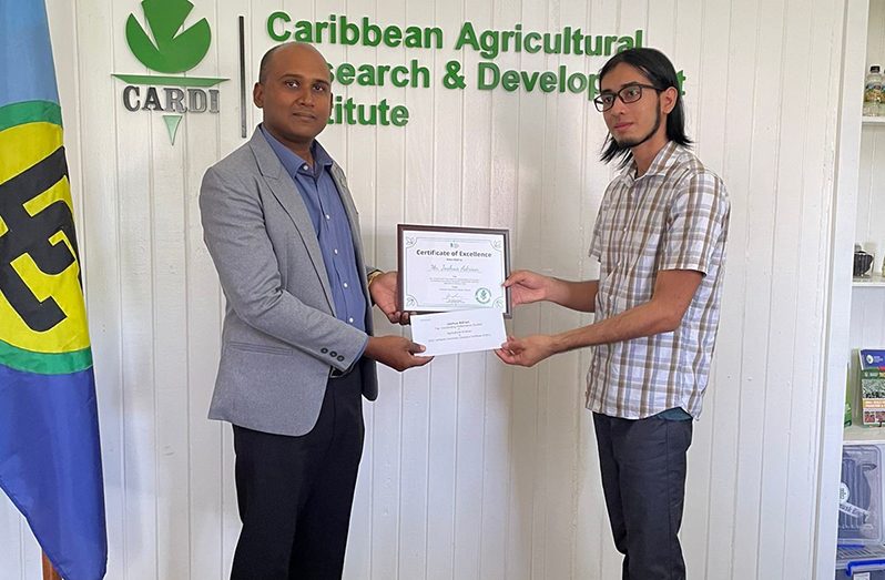 Guyana’s representative of CARDI, Jhaman Kundun presents the award to Joshua Adrian