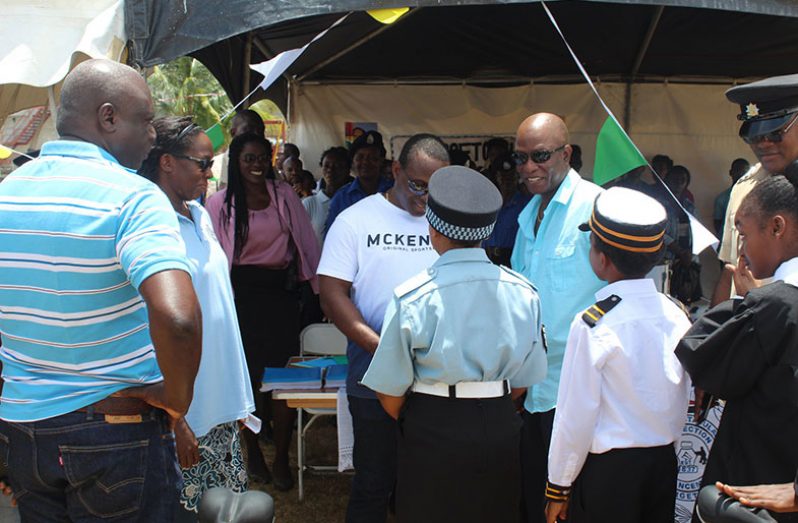 Deputy Commissioner ‘Administration’ Paul Williams and Commander ‘A’ Division, Assistant Commissioner Marlon Chapman interacting with youths dressed in their law enforcement attire.