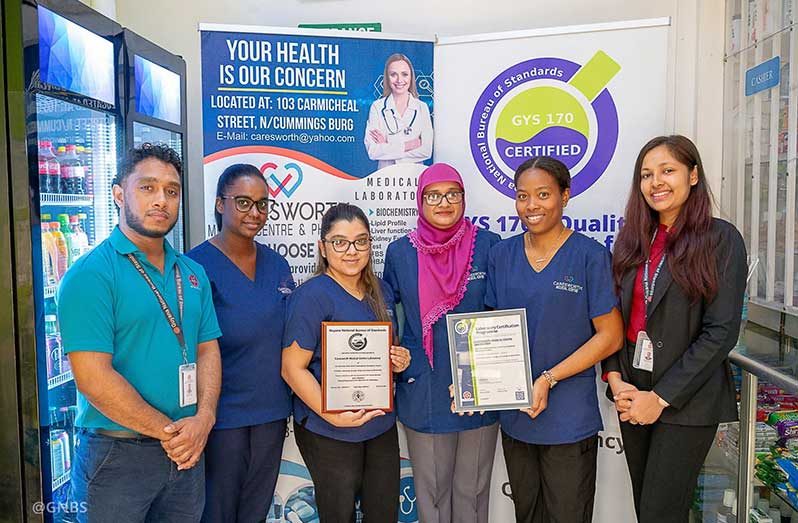 Bibi Nafeeza Bacchus (centre) with staff of Caresworth Medical Center and Pharmacy Laboratory and GNBS representatives. Her business was recertified in February this year