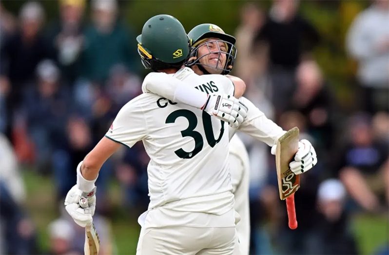 Alex Carey and Pat Cummins embrace after Australia got the winning runs  •  (Getty Images)