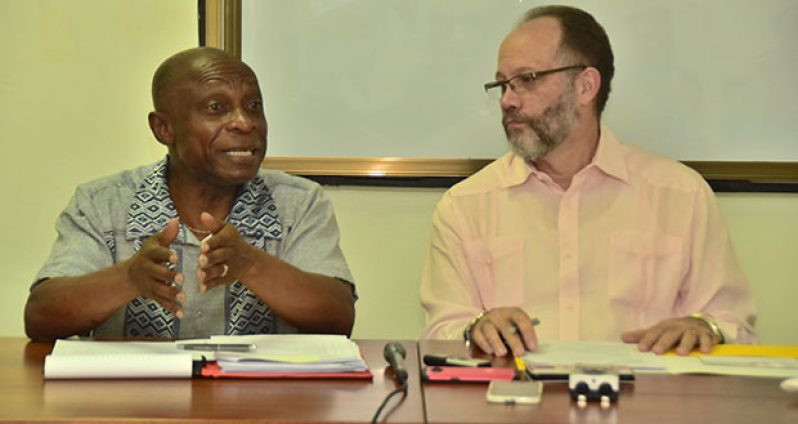 Caricom Secretary-General Irwin LaRocque listens to Minister of Foreign Affairs Carl Greenidge on Saturday during an informative session held at the Foreign Service Institute