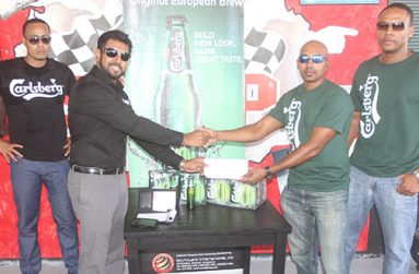 Southland International CEO Irzad Zamal presents GMR&SC treasurer Handel Singh with the sponsorship cheque while secretary Carey Griffith (first from left) and Carlsberg representative look on (Sonell Nelson photo)