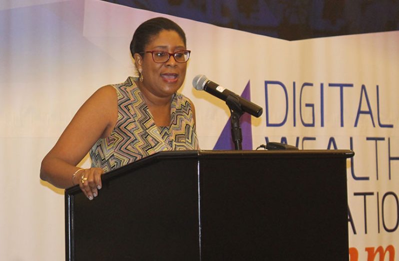 Minister of Public Telecommunications Cathy Hughes speaks of the advancement made in information and communication technology over the last year at the Digital Wealth Creation Summit on Saturday