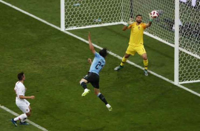 Uruguay's Edinson Cavani scores their first goal past Portugal's Rui Patricio. REUTERS/Sergio Perez