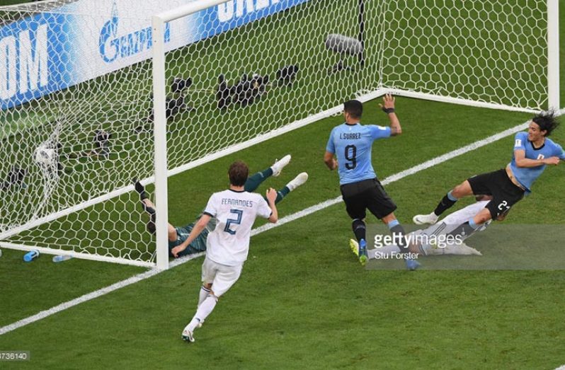 Uruguay player Edinson Cavani (r) scores the third Uruguay goal during the 2018 FIFA World Cup Russia group A match between Uruguay and Russia at Samara Arena on June 25, 2018 in Samara, Russia. (Photo by Stu Forster/Getty Images)