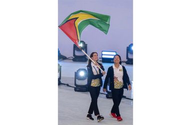 Ceili Peterson and her Coach Yvette Yong carrying the Golden Arrowhead proudly at the Opening Ceremony