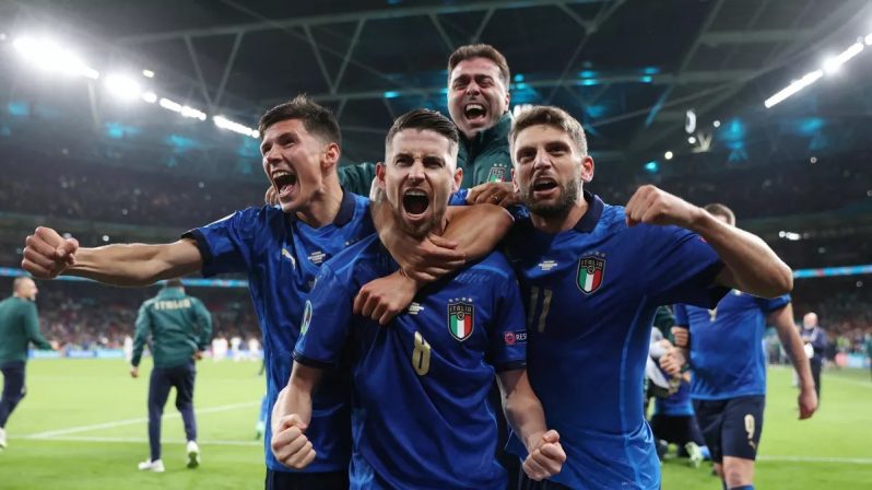 Italy's midfielder Jorginho (C) celebrates with teammates after scoring in a penalty shootout and winning the UEFA EURO 2020 semi-final football match between Italy and Spain at Wembley Stadium in London. (Image credit: Getty Images)