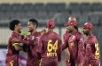 Akeal Hosein (second from left) won the game in the Super Over • Oct 21, 2025 • AFP/Getty Images