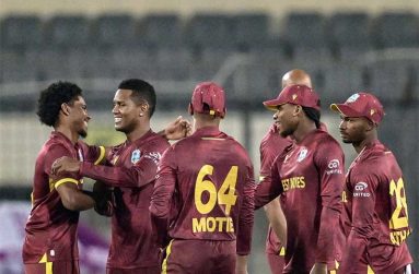 Akeal Hosein (second from left) won the game in the Super Over • Oct 21, 2025 • AFP/Getty Images