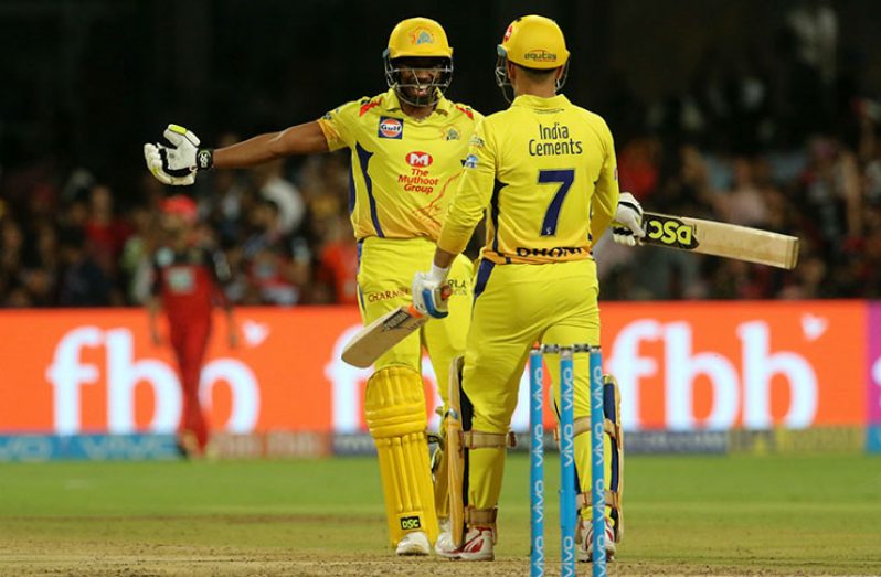We did it, skipper! Dwayne Bravo rushes in to celebrate with Dhoni after the win was achieved in the last over. (BCCI)