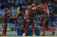 Usman Tariq (2R) and Akeal Hosein (R) of Trinbago Knight Riders celebrate the dismissal of Johnson Charles of Saint Lucia Kings (Photo by Randy Brooks/CPL T20 via Getty Images)