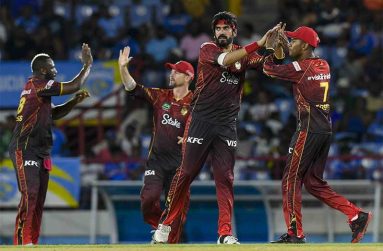 Usman Tariq (2R) and Akeal Hosein (R) of Trinbago Knight Riders celebrate the dismissal of Johnson Charles of Saint Lucia Kings (Photo by Randy Brooks/CPL T20 via Getty Images)