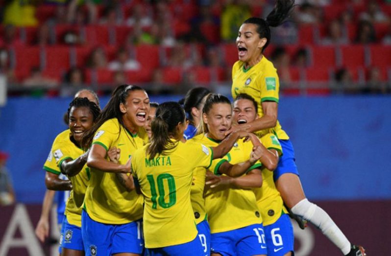 Brazil's players celebrate after Marta's record-breaking goal against Italy. (Philippe Huguen/AFP)