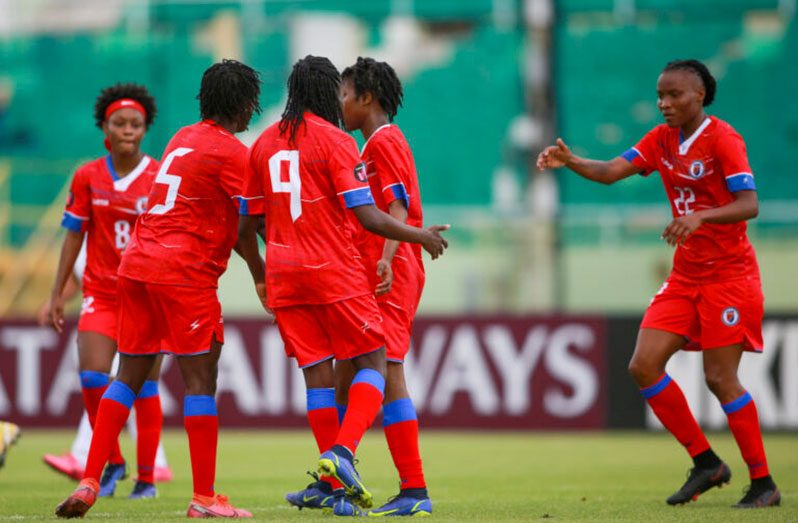 Rosellor Borgella (right) of Haiti celebrates with her teammates after scoring four goals in a victory against St. Vincent and the Grenadines in Cuba on Sunday. (Photo: CONCACAF)