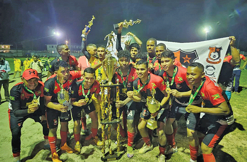 Tabatinga FC celebrate their championship trophy.