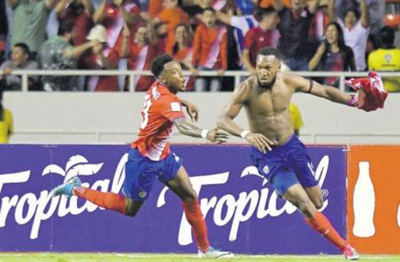 Costa Rica's Kendall Waston (right) celebrates with teammate Rodney Wallace after scoring against Honduras during their 2018 World Cup qualifying football match in San Jose. The game ended 1-1, giving Costa Rica the point they needed to secure their World Cup spot. (Photo: AFP)