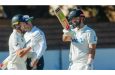 Daryl Mitchell celebrates his fifty as Nathan Smith looks on • (Zimbabwe Cricket)