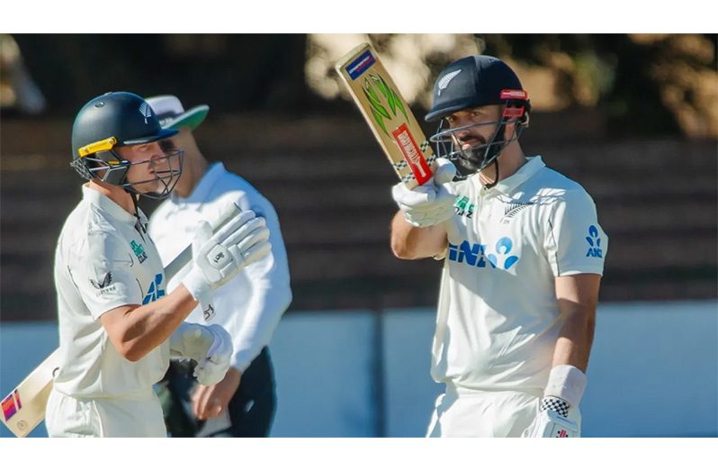 Daryl Mitchell celebrates his fifty as Nathan Smith looks on • (Zimbabwe Cricket)