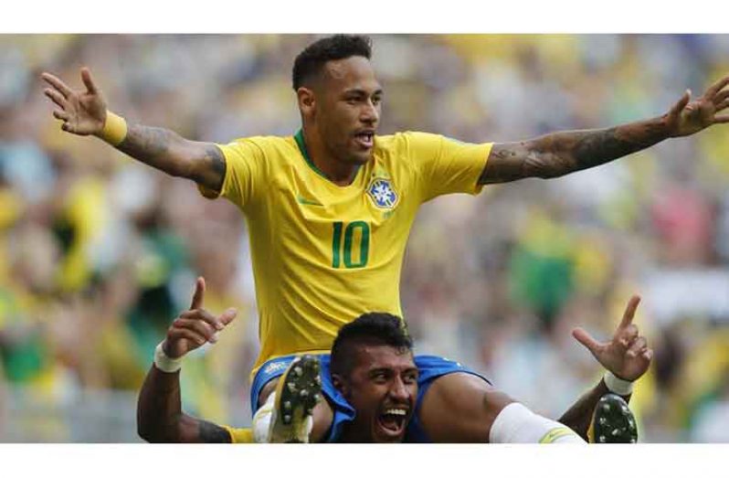 Brazil's Neymar, top, celebrates with team mate Paulinho after scoring his side's opening goal. (Hindustan Times)
