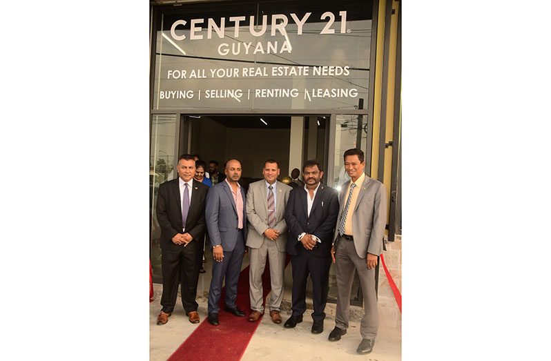 From left: Chief Executive Officer (CEO) of GO-Invest, Dr. Peter Ramsaroop; Managing Director of the Century 21 Guyana franchise, Chief Samsair; Minister of Housing and Water, Colin Croal, and at extreme left, Chairman of the Private Sector Commission (PSC) Paul Cheong after the formal ribbon cutting exercise at the Century 21 Guyana franchise office on Lamaha Street, Georgetown (Adrian Narine photo)