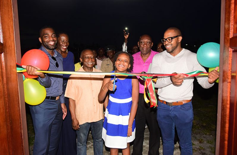 Minister of Foreign Affairs Carl Greenidge (third left), Ground Structures Engineering Consultants Inc proprietor Charles Ceres (second right) and his two sons Abdel and Assad look on as his daughter Chidimma, cuts the ceremonial ribbon to officially open the company’s Liliendaal office.