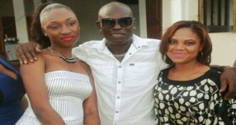 In happier times, – Guyana’s first World Champion Andrew ‘Six Head’ Lewis is seen with two of his daughters, Annastatia (left) and Omalesa Lewis.
