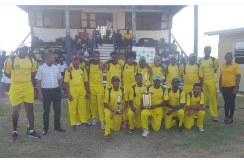 A jubilant Essequibo team celebrate with their championship trophy in . the presence of GCB secretary Anand Sanasie.